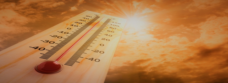 Thermometer with shining sun background