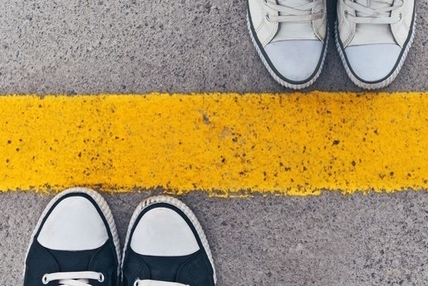 Shoes at a painted yellow line